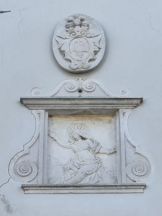 The arms, and the Madonna beneath them