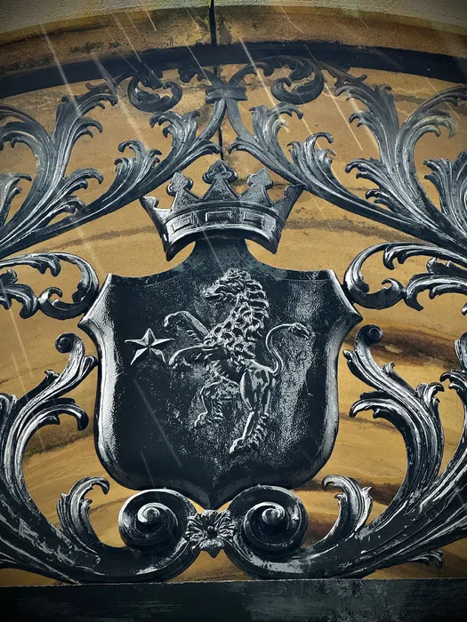 The other family's arms, in painted ironwork